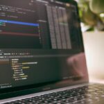 A laptop screen showing programming code and debugging tools, ideal for tech topics.