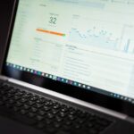 A laptop displaying an analytics dashboard with real-time data tracking and analysis tools.