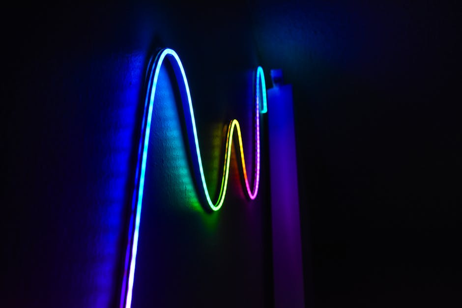 Colorful neon wave pattern LED lights illuminating a dark room for a modern home decor aesthetic.