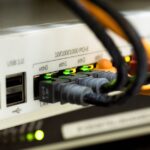 Detailed close-up of ethernet cables and network connections on a router, showcasing modern technology.